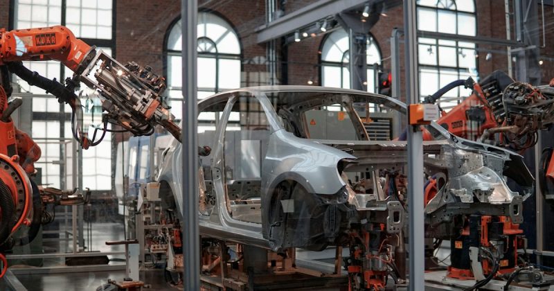 Automated robots working on a vehicle body in an automotive assembly plant